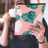 a girl is holding and viewing personalized iPad folio case with Pink Flower 2 design